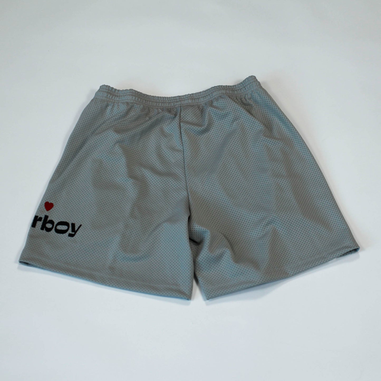 Back view of our Flowerboy black basketball shorts with printed Flowerboy Logo with red heart and a Flowerboy Tag.