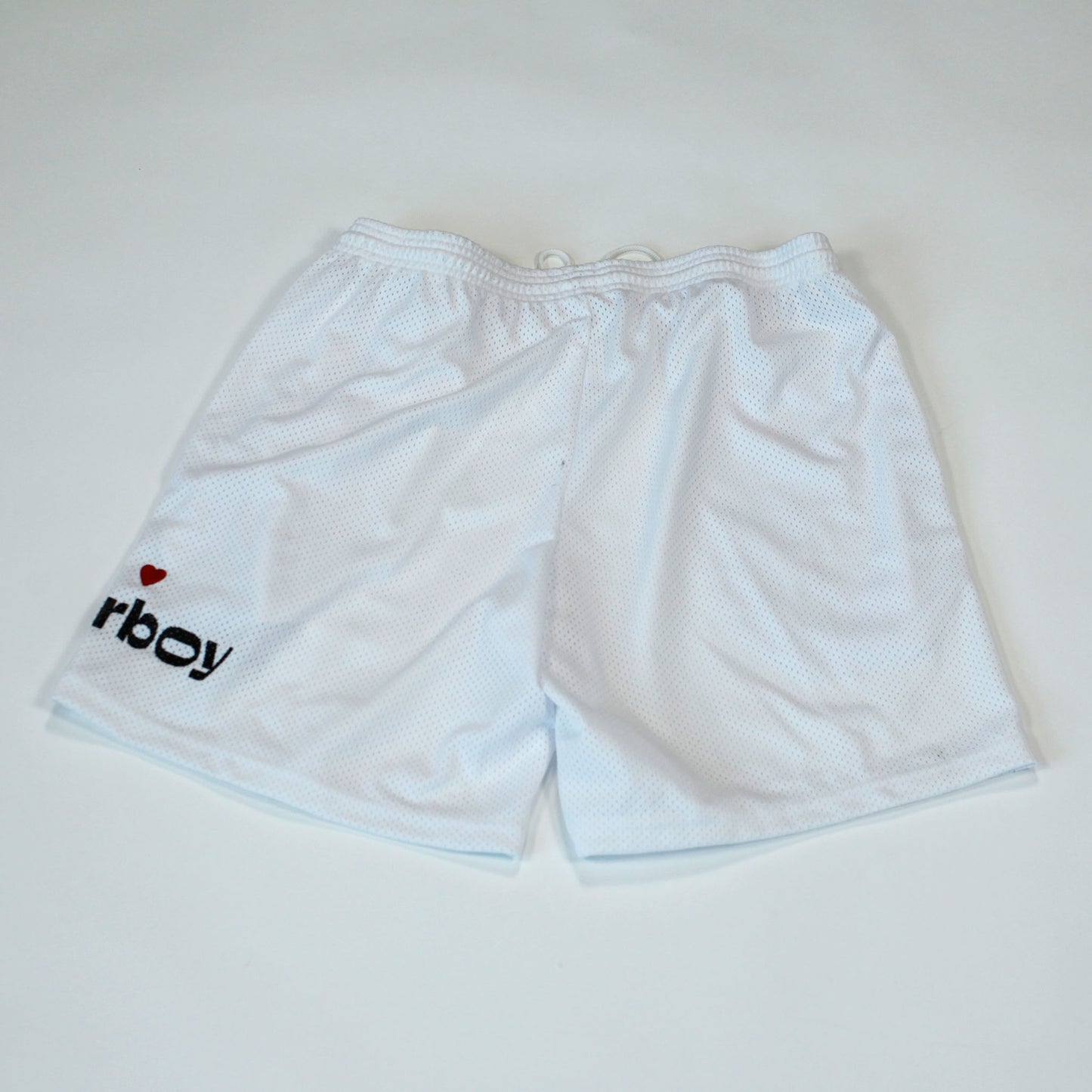 Back view of our Flowerboy black basketball shorts with printed Flowerboy Logo with red heart and a Flowerboy Tag.