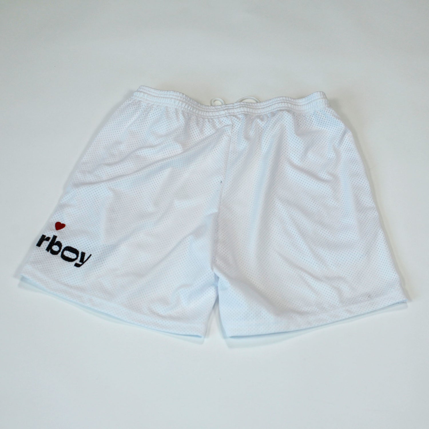 Back view of our Flowerboy black basketball shorts with printed Flowerboy Logo with red heart and a Flowerboy Tag.